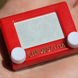 This nostalgic favourite is fully functioning. Simply twist the knobs to draw real designs, then
shake to erase, just like the original!
