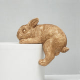 This adorable shelf bunny is designed to hang perfectly from the edge of your bookshelf or side table.